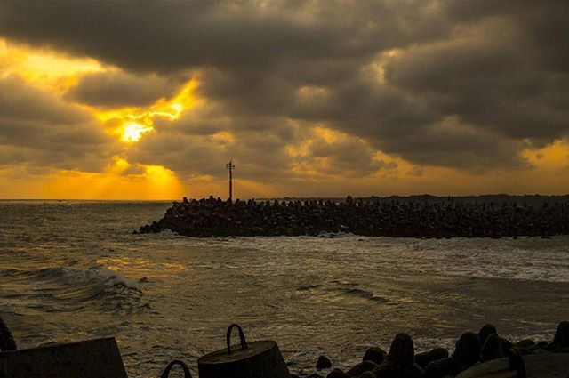 sunset, sea, water, sky, orange color, cloud - sky, scenics, beauty in nature, horizon over water, dramatic sky, tranquil scene, tranquility, silhouette, cloudy, idyllic, nature, nautical vessel, pier, cloud, beach