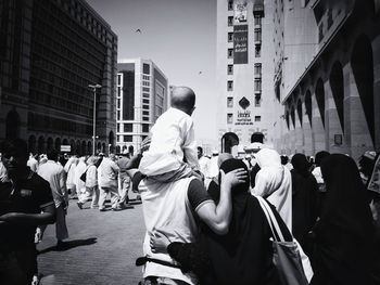 Group of people walking in front of buildings