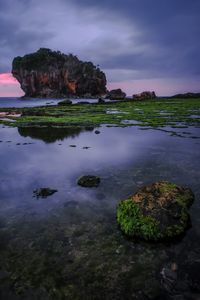 Scenic view of sea and rock formations against sky