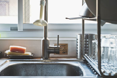 Close-up of kitchen sink against window