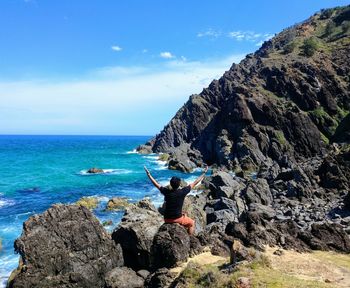 Scenic view of rocks in sea against sky