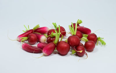 Close-up of cherries over white background