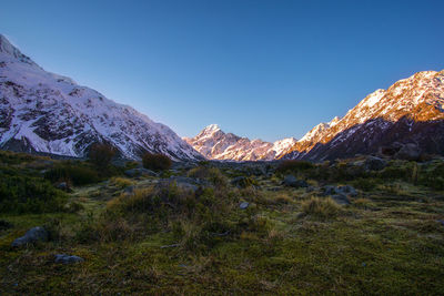 Scenic view of snowcapped mountains against clear blue sky