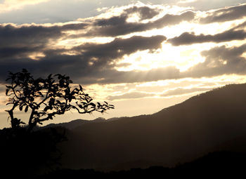 Scenic view of silhouette mountains against sky at sunset