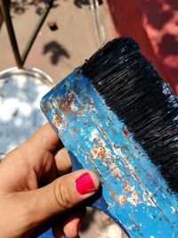 Cropped hand of woman holding paintbrush