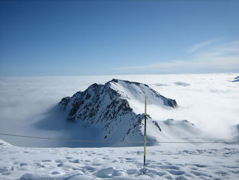 Scenic view of snowcapped mountain against blue sky