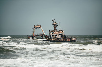 Fisherman boat in sea against clear sky