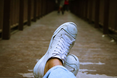 Low section of person standing on footpath