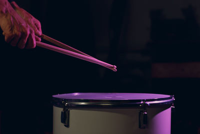 Close-up of hand on pink stage