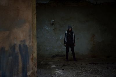 Woman standing in abandoned room