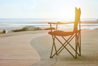 Folding chair on the sea,sunset