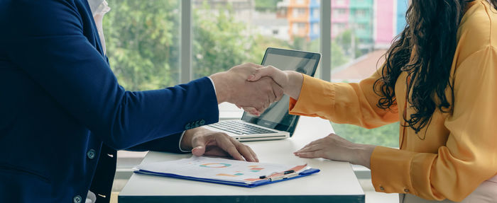 Midsection of business colleagues working at office