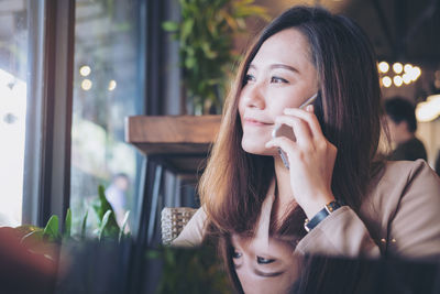 Woman talking on phone at cafe