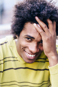 Portrait of smiling man with hand in hair