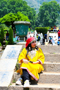 Rear view of people sitting on steps