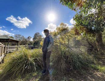 Man standing by plants against sky