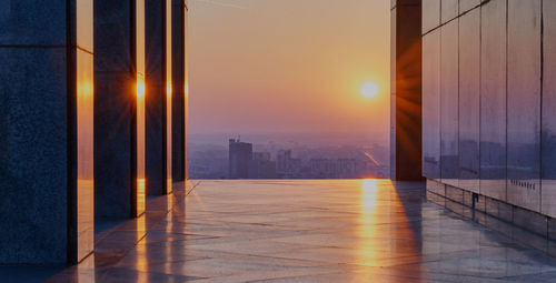 Scenic view of illuminated building against sky during sunset