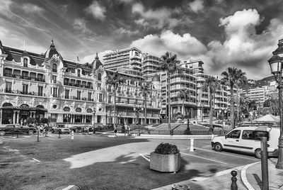 City street by buildings against sky