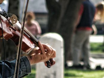 Cropped image of man playing violin