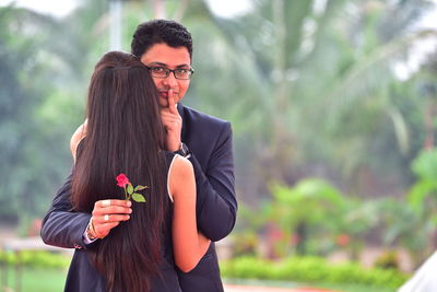 Portrait of bridegroom standing with bride during wedding ceremony