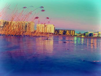 Scenic view of sea by city against sky