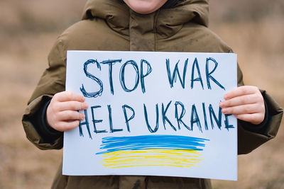 War of russia against ukraine. crying boy asks to stop the war in ukraine.