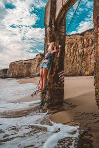 Young woman swinging at beach