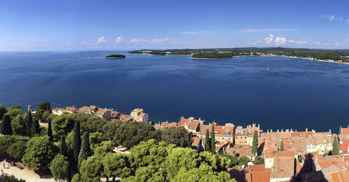 High angle view of townscape by sea against sky