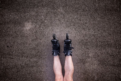 Low section of man with roller skates on road