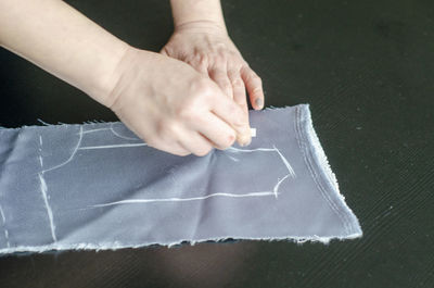 Midsection of person holding paper