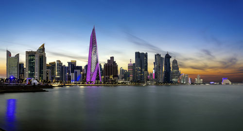 Illuminated city at waterfront