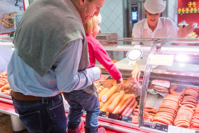 Midsection of man standing at market stall