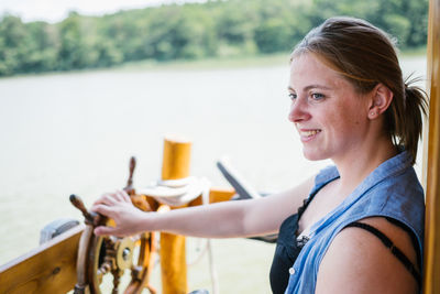 Side view of smiling woman in boat