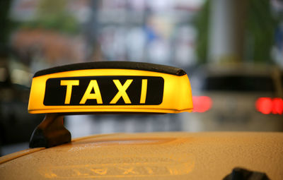 Close-up of yellow sign on road