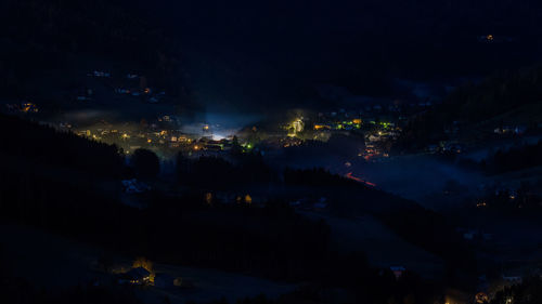 High angle view of illuminated buildings in city at night