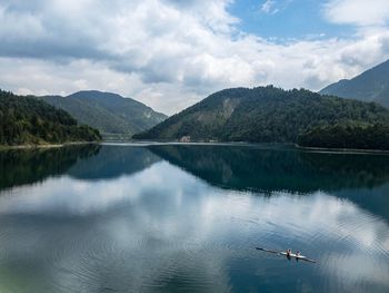 Scenic view of lake and mountains against sky