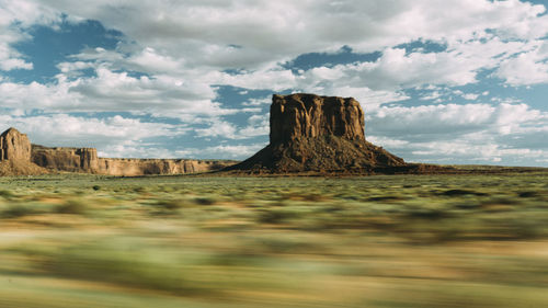 Rock formations on landscape against sky