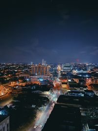 High angle view of illuminated buildings in city at night