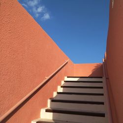 Low angle view of steps against blue sky