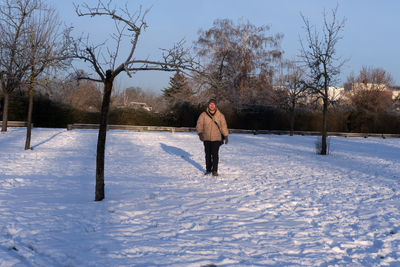 Full length of man standing on snow covered field