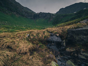 Scenic view of waterfall against sky