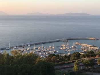 High angle view of sea by mountain against sky