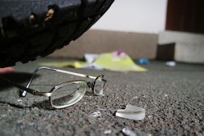 Close-up of broken eyeglasses on road