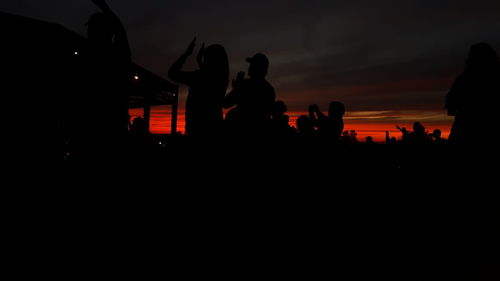 Silhouette of ferris wheel at night