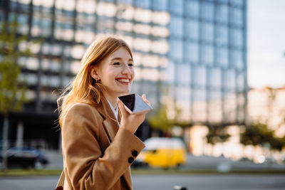 Professional businesswoman smiling in city street portrait