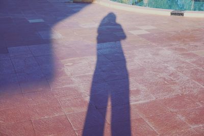 Low section of woman standing on tiled floor