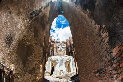 Low angle view of statue against historic building