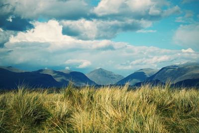 Scenic view of mountains against cloudy sky