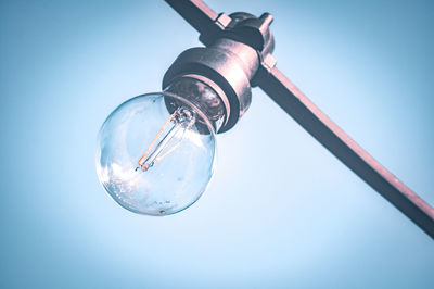 Low angle view of light bulb against sky