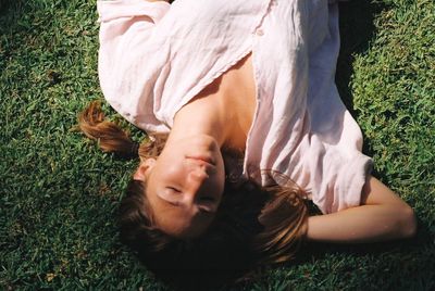 High angle view of woman lying on field